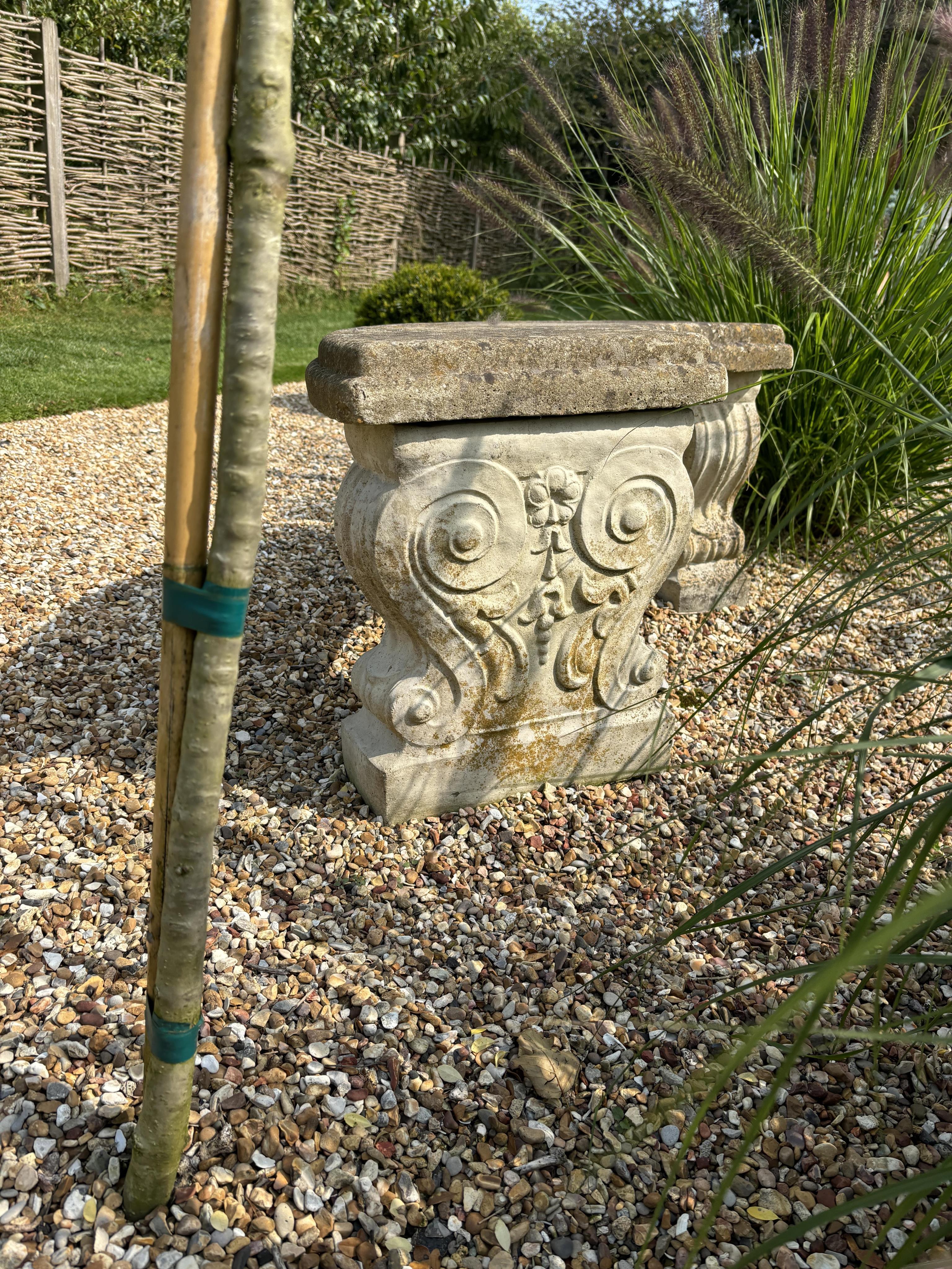 Two reconstituted stone benches, one curved, width 110cm, height 40cm, the other straight, width 114cm, height 44cm. Condition - both weathered, otherwise good condition